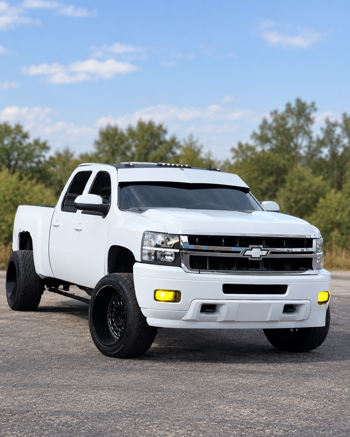 White Chevrolet Silverado with TRUBLU Fab V-style drop visor, front three-quarter view