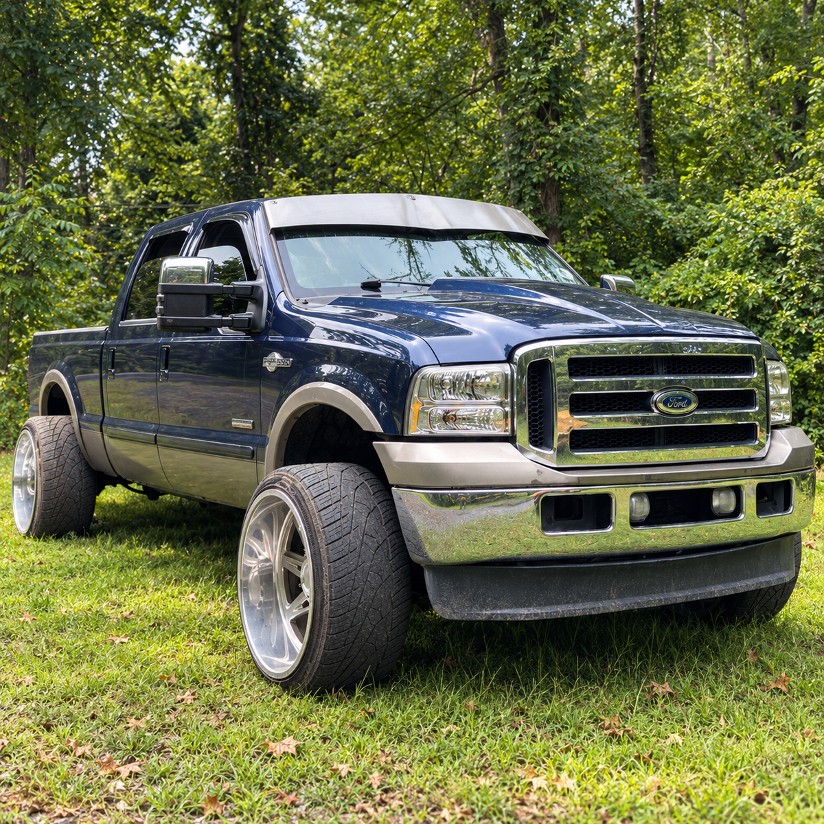 Dark blue Ford Super Duty with a raw-finish TRUBLU Fab 5-inch V drop visor, front three-quarter view
