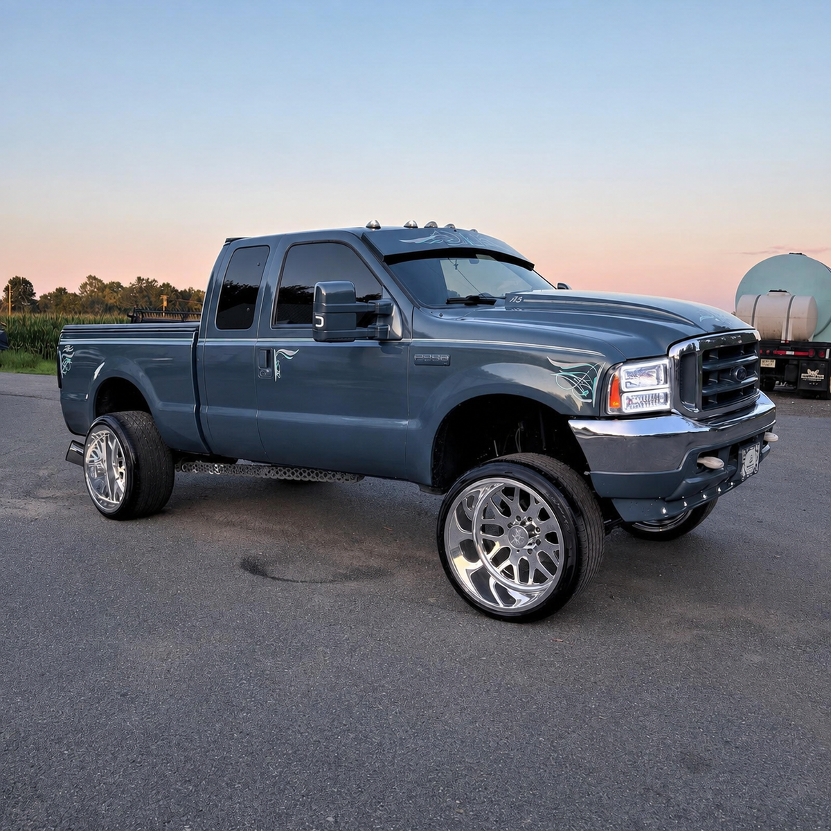 Custom gray-blue Ford Super Duty displaying a TRUBLU Fab straight drop visor and hand-painted pinstriping