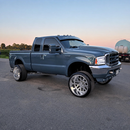 Custom gray-blue Ford Super Duty displaying a TRUBLU Fab straight drop visor and hand-painted pinstriping