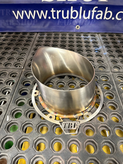 Stainless steel TBF exhaust component on perforated metal surface