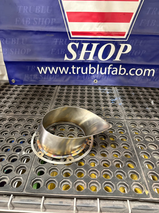 Stainless steel custom pipe fitting on perforated metal surface