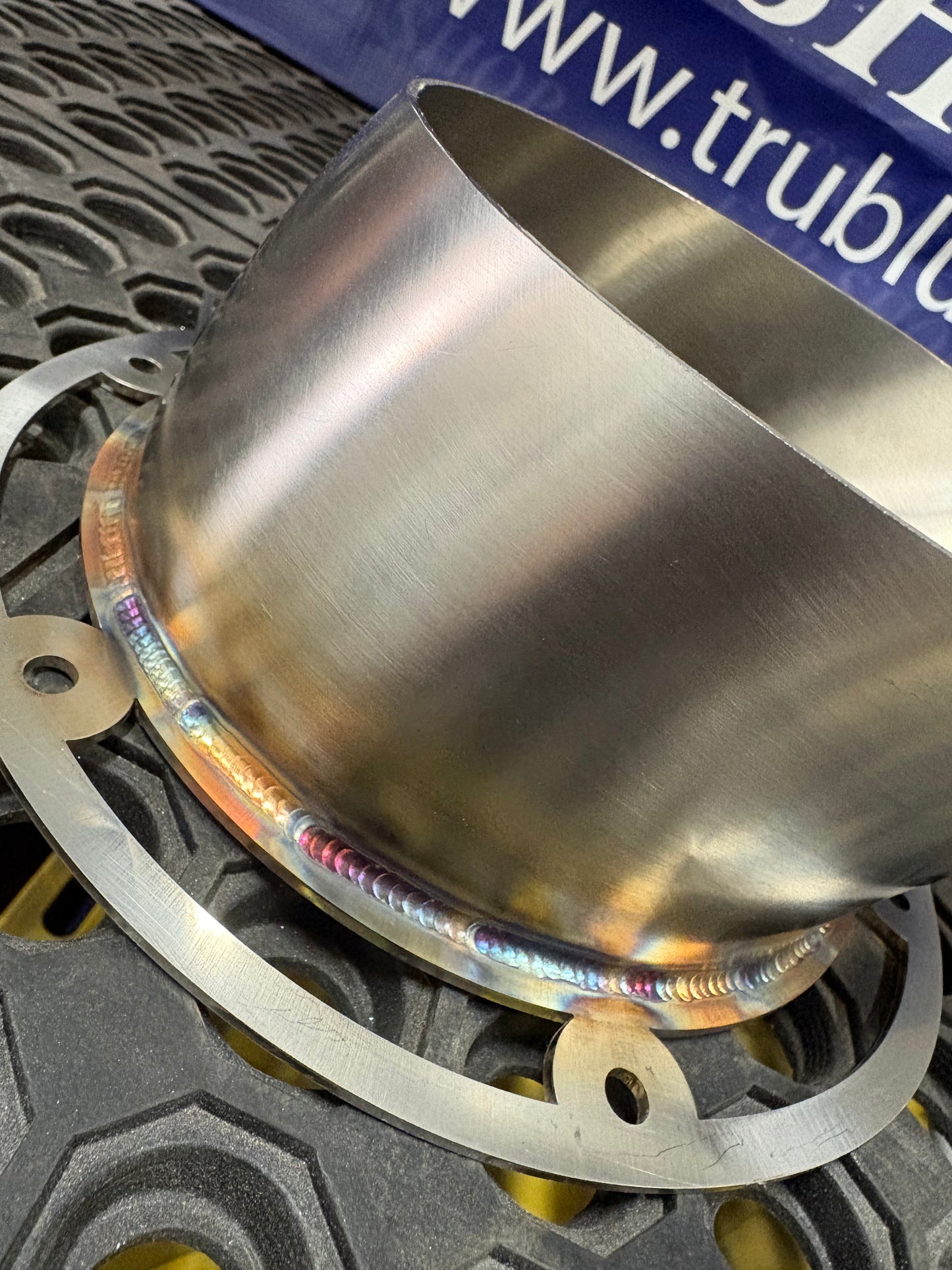 Stainless steel exhaust component with rainbow weld, precision crafted for performance