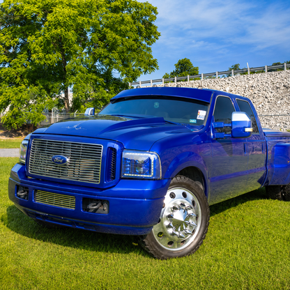 Dark blue Ford Super Duty dually with TRUBLU Fab straight drop visor, front three-quarter view