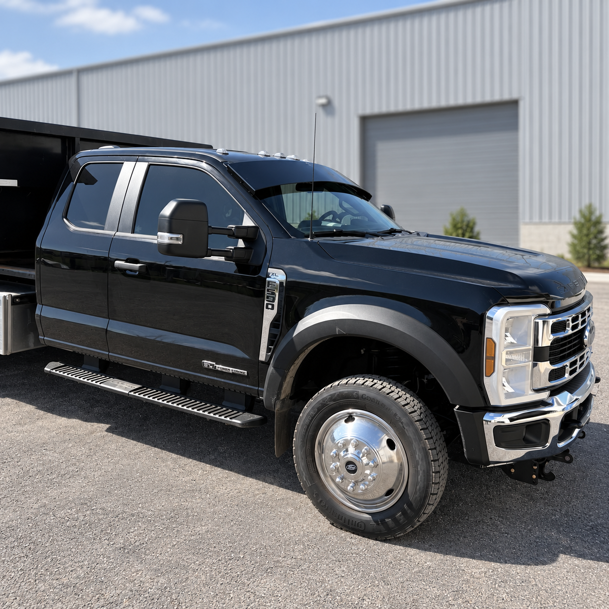 Side profile of a black Alumiduty drop visor installed on a Ford F-550