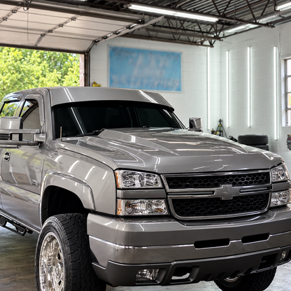 Close view of a finished straight drop visor installed on a silver Chevrolet Silverado