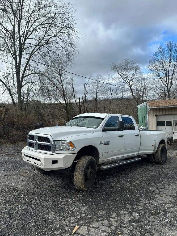 White Ram dually showing straight drop visor from the front driver-side view