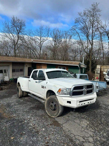 White Ram dually with straight drop visor installed, front passenger-side view