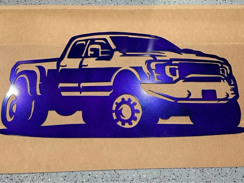 Purple metal wall art cutout of a pickup truck on a brown background
