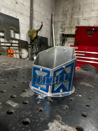 Metal fabrication shop accessory with blue accents on perforated steel workbench