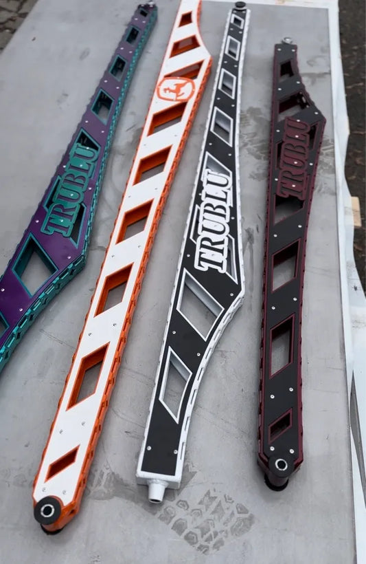 Four colorful custom metal truck frame braces with geometric cutouts and TRUBLU logos.