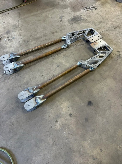 Heavy-duty metal suspension link arms for off-road vehicle on workshop floor